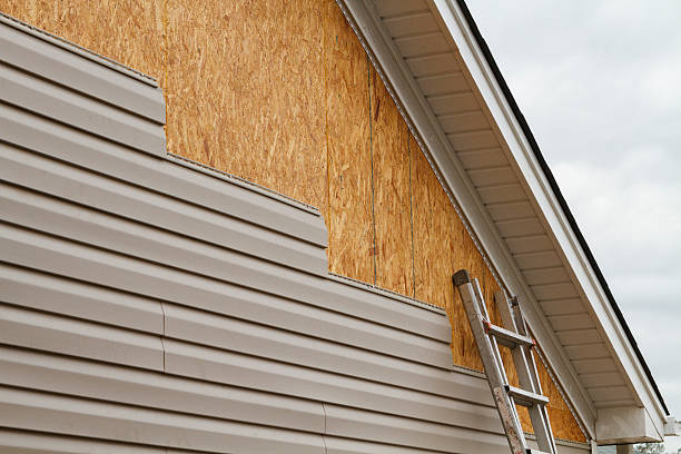 Professional Siding technician working in East Meadow, NY